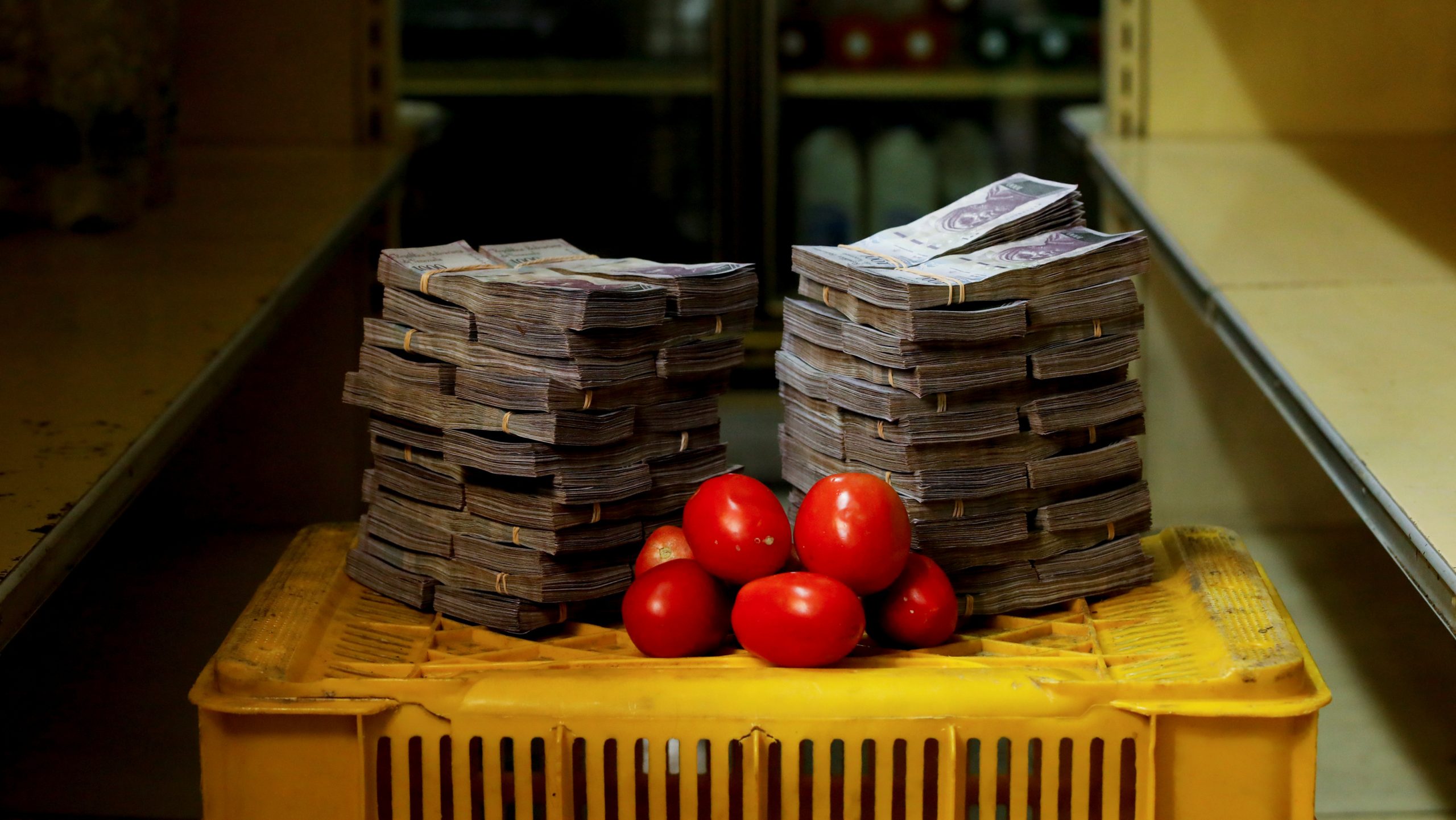 A Kilogram, Or Just Over 2 Pounds, Of Tomatoes Sits Next To The 5 Million "strong" Bolivars Needed Just To Buy The Bunch At An Informal Market In A Low-income Neighborhood Of Venezuela's Capital, Caracas.